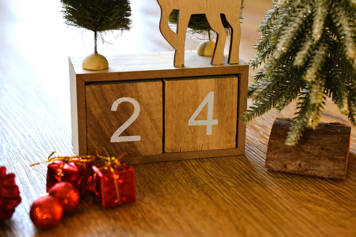 Advent calendar showing December 24 among red Christmas decorations